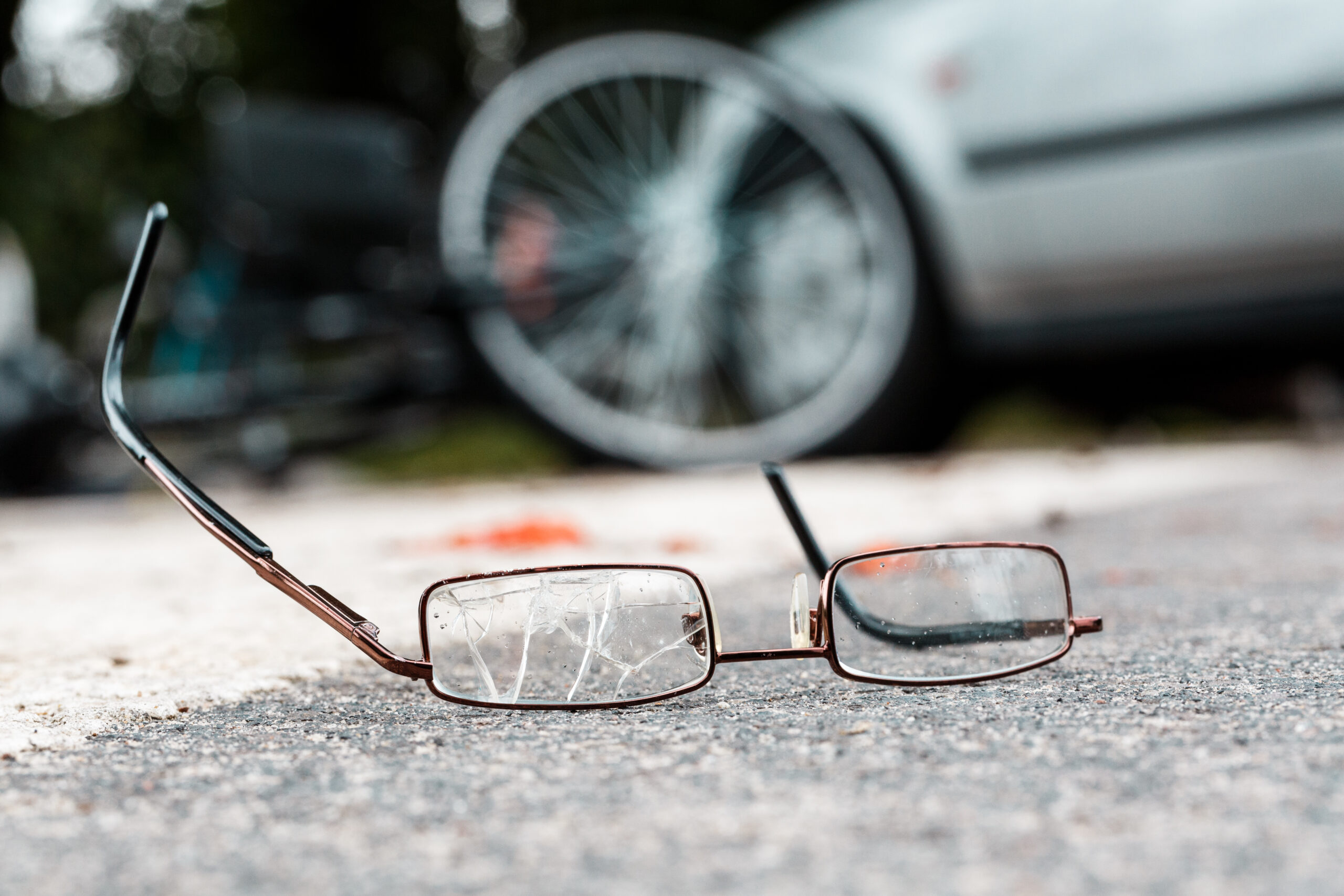 Broken glasses of fatal car accident victim on the street